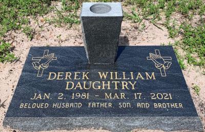 single flat american black headstone with gold lettering